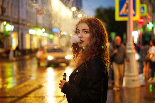 A woman vaping on the street
